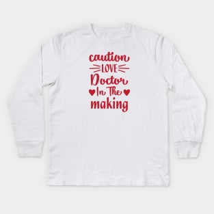 caution love doctor in the making Kids Long Sleeve T-Shirt